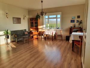 a living room with a couch and a table at Tjörn 1 in Hvammstangi