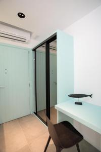 a desk and a chair in a room at Majo Suites Hotel in Agia Anna Naxos