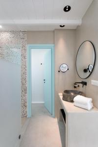 a bathroom with a sink and a mirror at Majo Suites Hotel in Agia Anna Naxos +225 photos
