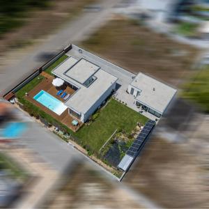 an aerial view of a house with a swimming pool at AMARÉ Studio in Ovar