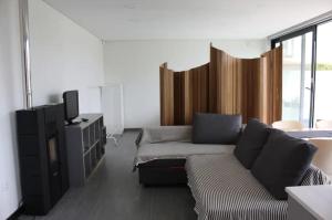a living room with a couch and a tv at AMARÉ Studio in Ovar