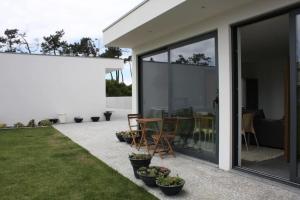 a patio with glass doors and a table with chairs at AMARÉ Studio in Ovar