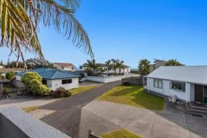 a view of a house with a yard at Ohope Palms - Ohope Holiday Home in Ohope Beach