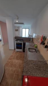 a kitchen with a counter with a sink in it at Suites y habitaciones en Edificación Amaralto in Manta +9 photos