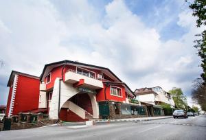 a red building on the side of a street at Hotel Boyana - Free Parking in Sofia