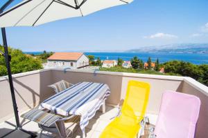 a patio with a table and chairs on a balcony at Villa Tereza in Splitska