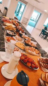 a buffet with many plates of food on a table at PARK VEREDAS FLAT 322 in Rio Quente
