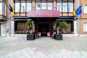 a entrance to a building with a sign on it at Grand Hotel Normandy by CW Hotel Collection in Bruges