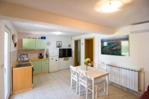 a kitchen and dining room with a table and chairs at Villa Tereza in Splitska