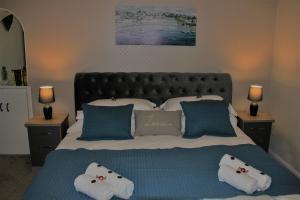 a large bed with two pillows on top of it at Bellevue Holiday Cottage in Gardenstown
