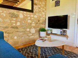 a living room with a blue couch and a table at Domaine des Varennes in Louresse-Rochemenier