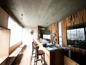 a kitchen with a bar with stools in it at tune HIGORO in Tateyama