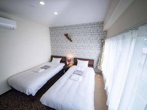 A bed or beds in a room at tune HIGORO