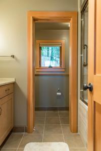 a bathroom with a walk in shower and a window at Private Home Overlooking Stevens Lake in Great Barrington +44 photos