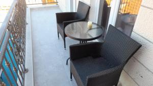 a table and chairs with a cup on a balcony at Apartments Lumbarda in Lumbarda