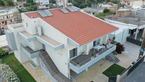 an overhead view of a white house with an orange roof at Galini Villas in Gerani