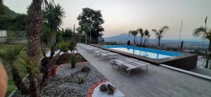 a swimming pool with chaise lounge chairs at Villa Mola Bed And Breakfast in Corbara