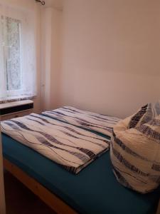 a bed sitting in a room with a window at Ferienhaus Schlothauer 1 in Tiszacsege
