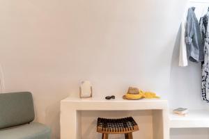 a white table with a phone and a chair at Santo Bloom Luxury Villas in Vóthon