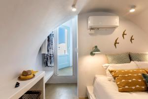 a small bedroom with a bed and a window at Santo Bloom Luxury Villas in Vóthon +117 photos