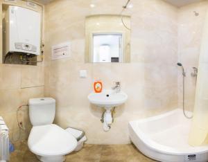 La salle de bains est pourvue de toilettes blanches et d'un lavabo. dans l'établissement New apartments in the city center - Kuznechna str. 26/1, à Kharkov