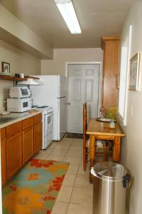 a kitchen with a table and a white refrigerator at Langridge Lodge in Alpine +14 photos