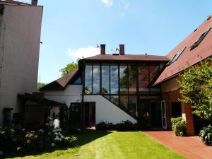 an external view of a house with large glass windows at Penzion Country Club in Žamberk