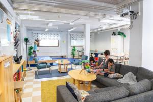 a group of children sitting on a couch in a living room at ISLO Hostel in Joensuu