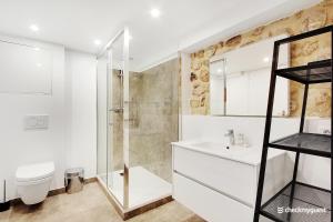 a bathroom with a shower and a toilet and a sink at CMG Faubourg Saint-Martin in Paris