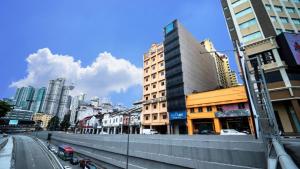 a city with tall buildings and a street with cars at Asia Like Boutique Hotel in Kuala Lumpur
