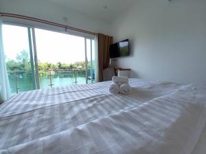 Postel nebo postele na pokoji v ubytování Pure Laguna Residence by Nice Sea Resort