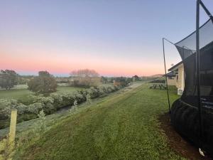 a view from the outside of a house with a view of a yard at Paraite Farmstay in New Plymouth