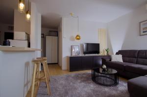 a living room with a couch and a table at Apartment Zagreb 213 in Zagreb