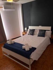 a bedroom with a white bed and white pillows at Hostal Baleàric in San Antonio