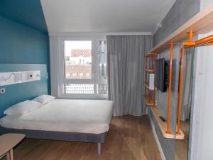 a small bedroom with a bed and a window at ibis budget Rouen Centre Rive Gauche in Rouen