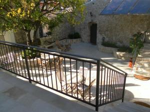 a black metal railing in front of a building at Apartments David in Perast