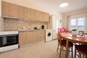 a kitchen with a table and a dining room at Seaview studio in Iraklitsa