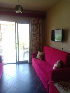 a living room with a pink couch and a tv at شاليهات بورتو مطروح فيو بحر Porto Matrouh Sea View Families Only in Marsa Matruh
