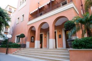a building with stairs in front of a building at Artemis Hotel in Cefalù