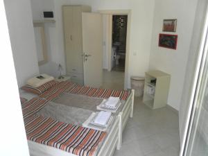 a small room with a bed and a bathroom at Apartments David in Perast