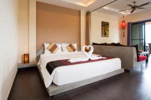 a bedroom with a bed with two swans on it at Koh Tao Heights Exclusive Apartments in Ko Tao