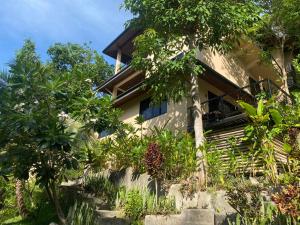 a house surrounded by trees and plants at Koh Tao Heights Exclusive Apartments in Koh Tao