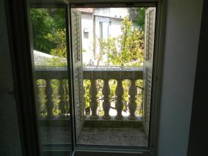 a glass door with a view of a balcony at Apartments David in Perast