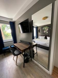 a bedroom with a bed and a table and a mirror at IQ Hotel Hannover in Hannover