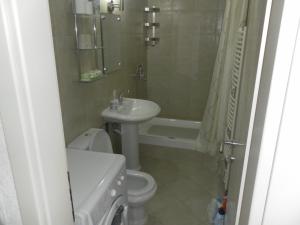 a bathroom with a sink and a toilet and a bath tub at Apartments David in Perast