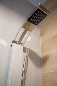 a stainless steel shower head in a bathroom at Hotel Pericles in Sami