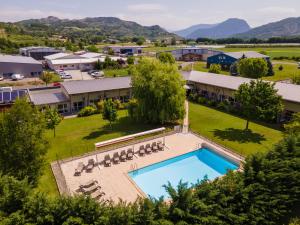 an aerial view of a resort with a swimming pool at The Originals Boutique, Hôtel Le Cap, Gap Sud in Tallard