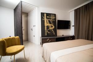 a hotel room with a bed and a chair at LUXURY apartment ROYAL IRIS in Njivice
