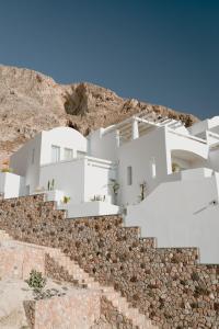a white house on top of a mountain at Epavlis Grace - Adults Only in Kamari