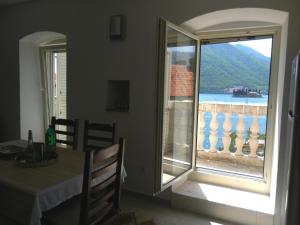 a room with a table and a window with a view at Apartments David in Perast
